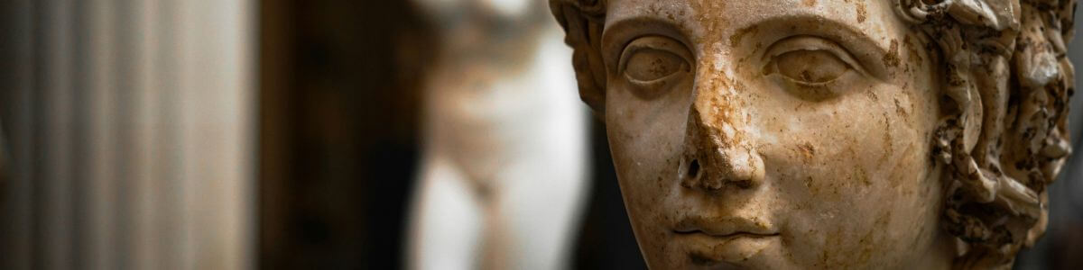 Close-up of the face of a female statue, symbolizing focus and contemplation.