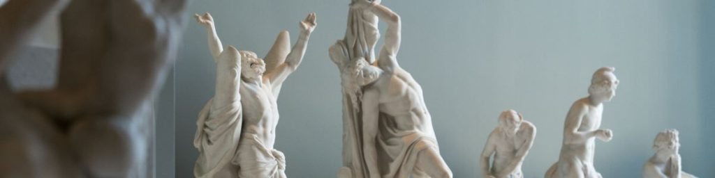 Group of ancient statues in different poses symbolizing external distractions and scattered attention.
