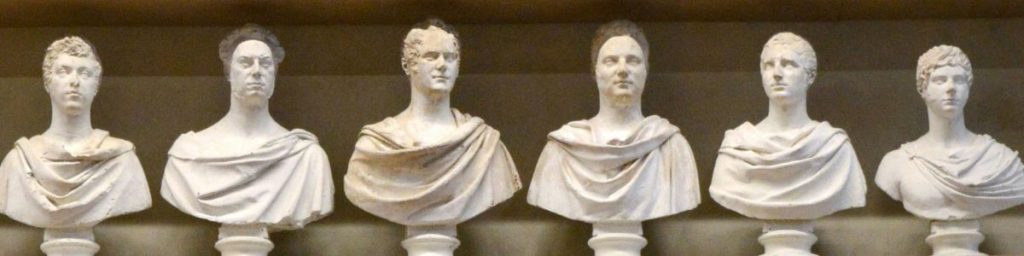 Row of six ancient busts on a shelf, representing structure, order, and stability of focus.