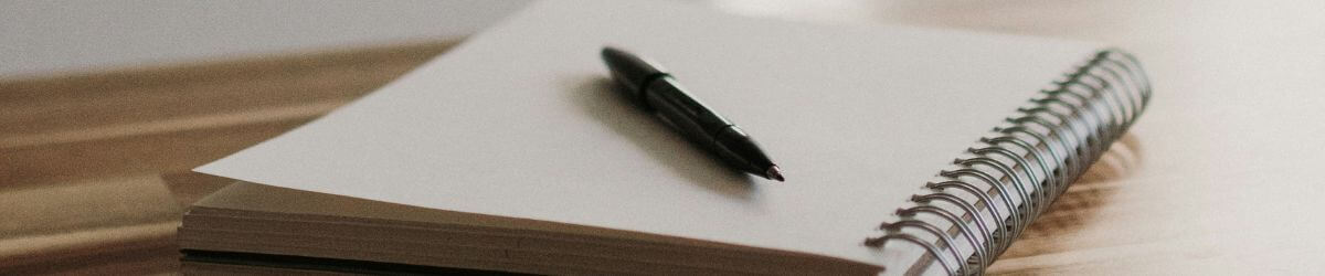 A pen on a notebook.