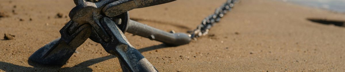 An anchor on a beach.